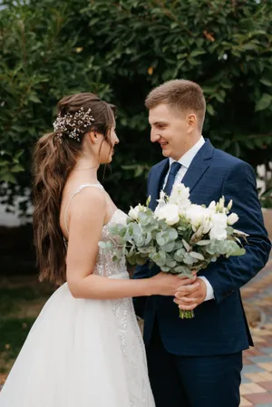 Happy couple celebrating their wedding outdoors with flowers.
