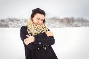 Attractive brunette lady wearing fashion jacket and scarf.