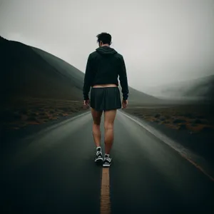 Majestic Mountain Sunset Hike: Adventurous Man Embracing Nature