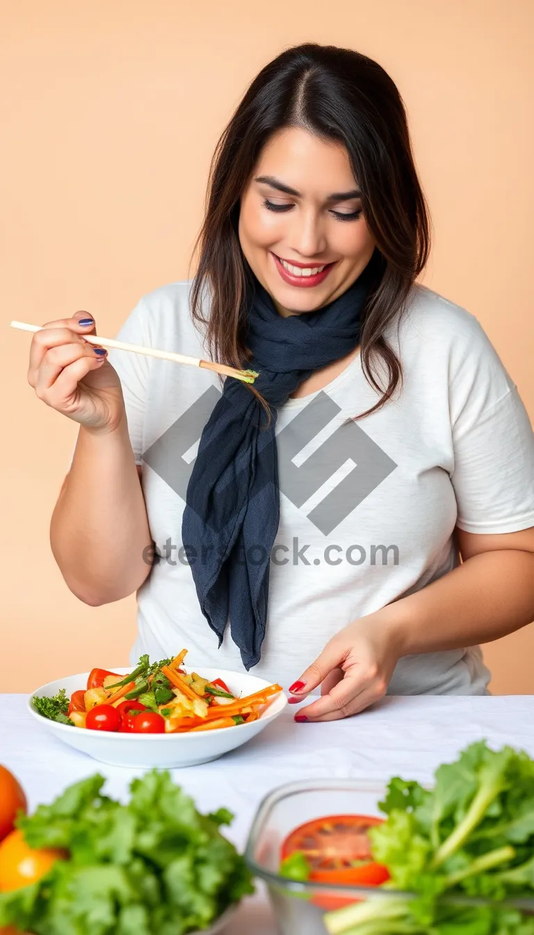 Picture of Happy Woman Eating Healthy Salad at Home.