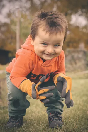 Happy boy smiling in the park with family