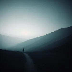 Golden Horizon Silhouetting Mountain Range at Sunset