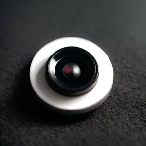 Shiny Black Electronic Device with Trackball: Sleek and Modern