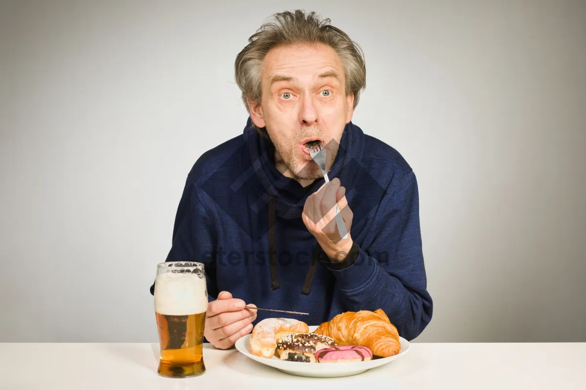 Picture of Happy senior couple enjoying meal at home.