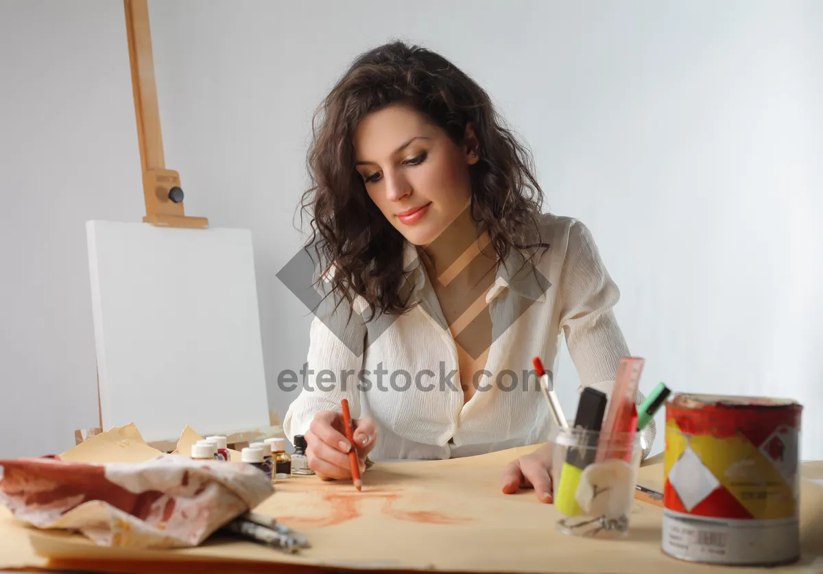 Picture of Smiling brunette businesswoman working on laptop at home office