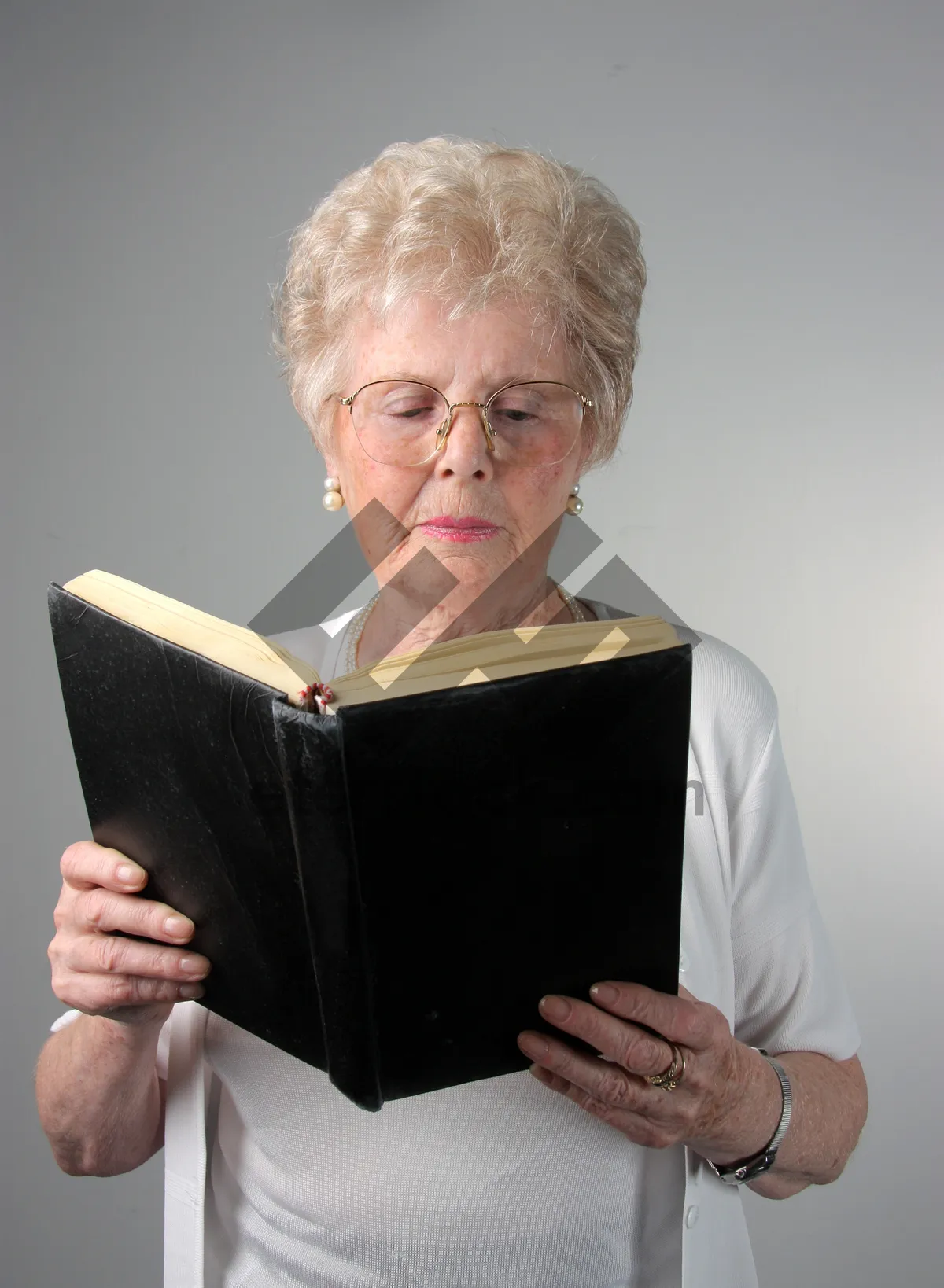 Picture of Happy elderly lady working on laptop at home office.