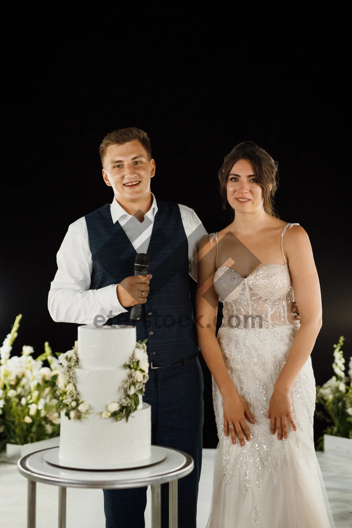 Picture of Happy bride and groom outdoors with flowers