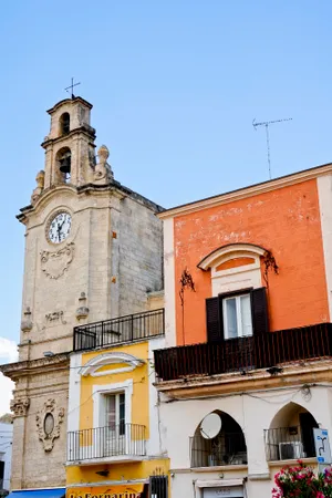 Historic cathedral tower with clock and bell.