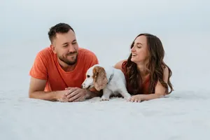 Happy man with cute cocker spaniel puppy.