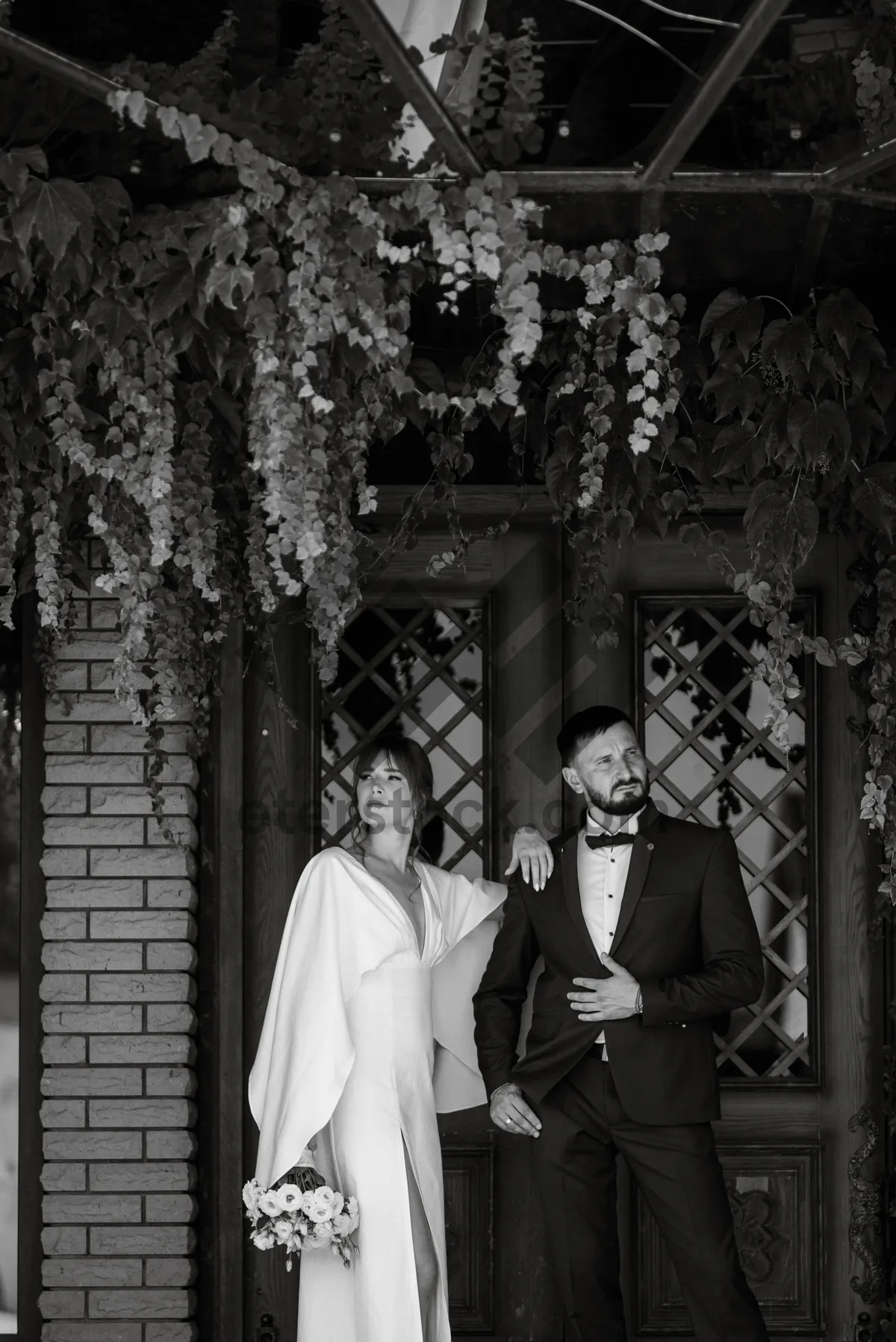 Picture of Portrait of adult groom posing with guillotine instrument.