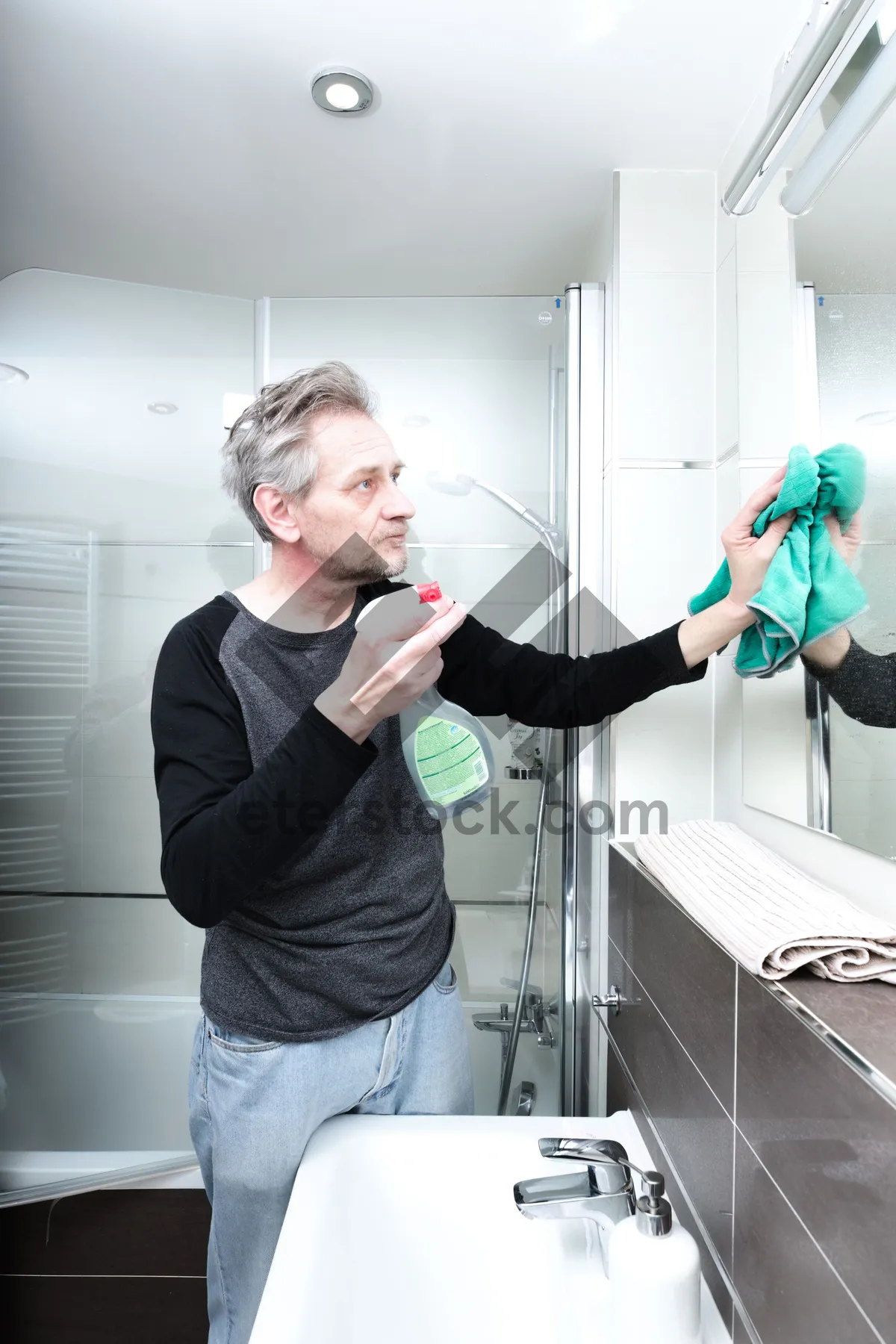 Picture of Smiling man with hand blower at home.