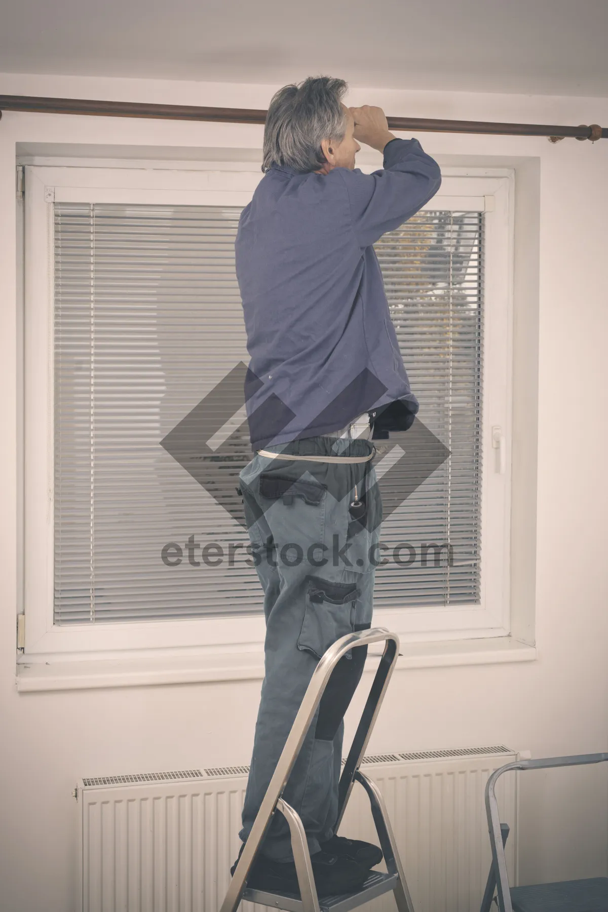 Picture of Happy man smiling on treadmill at home gym.