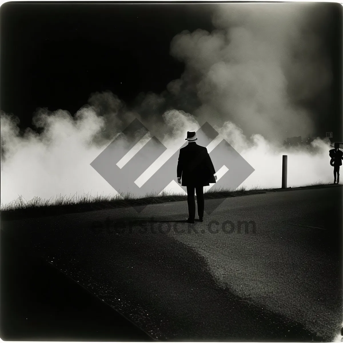 Picture of Sunset silhouette of man holding chemical weapon on beach.