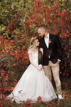 Happy Couple Celebrating Wedding Outdoors with Flowers