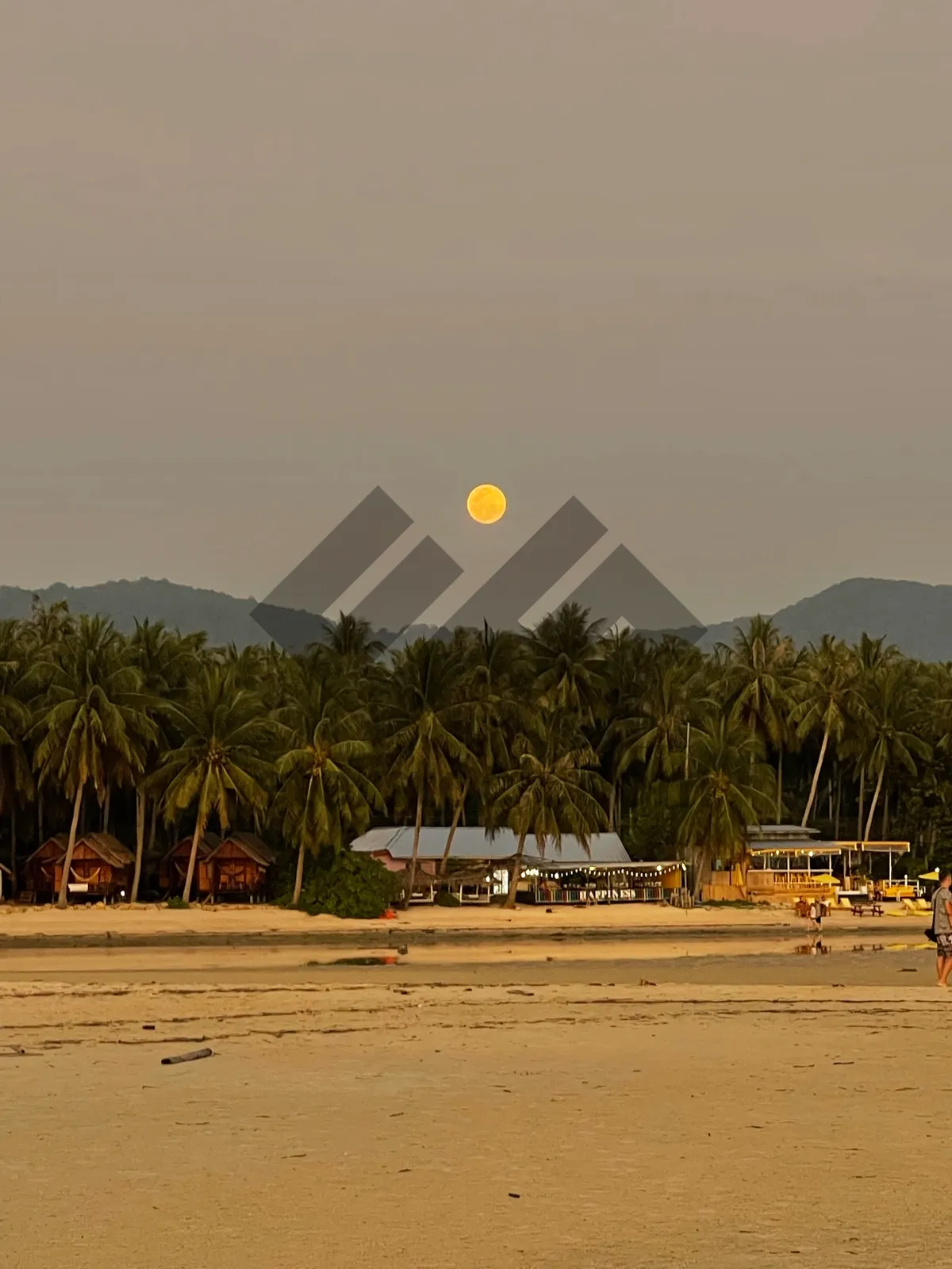 Picture of Sunset volleyball game equipment on tropical beach.