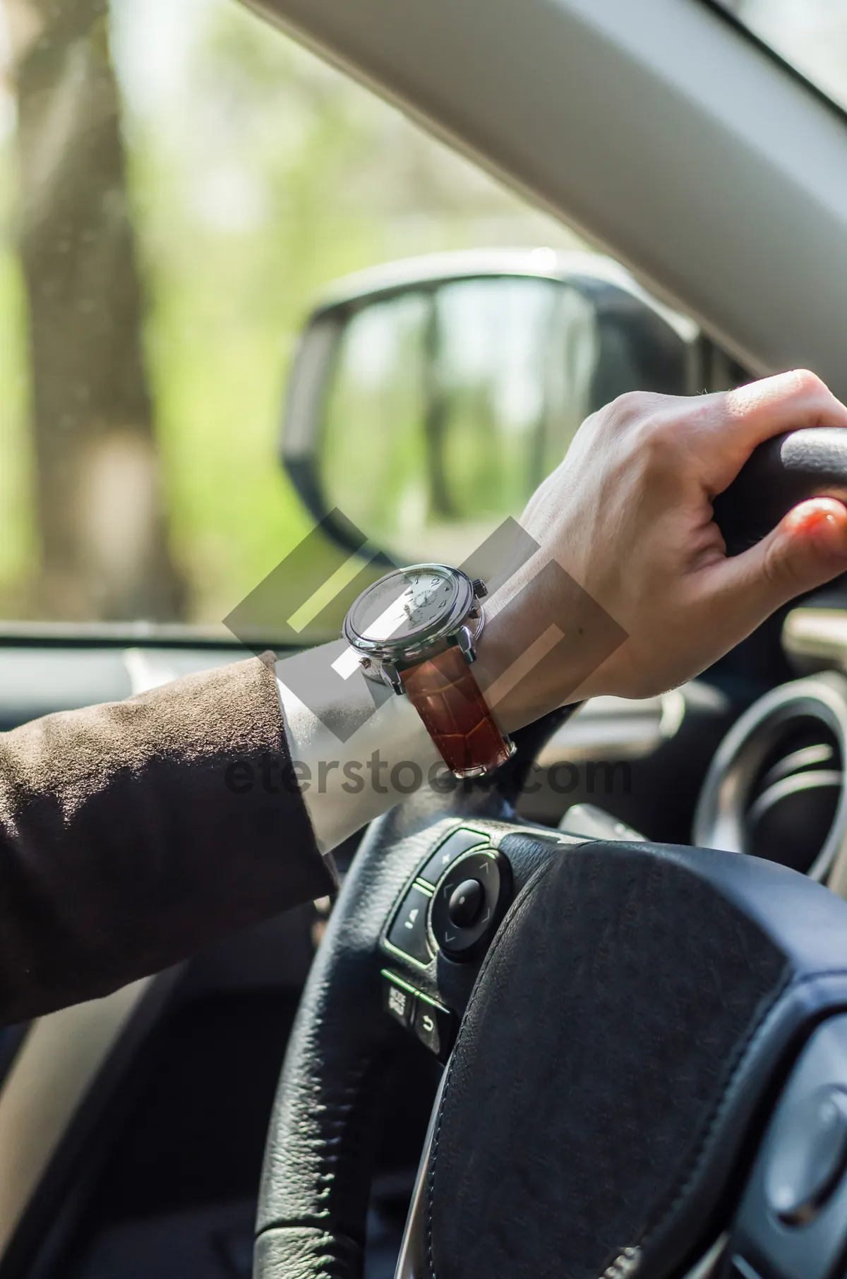 Picture of Man driving car, hand on steering wheel