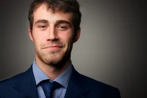 Smiling businessman in office suit and tie portrait.