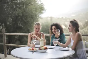 Happy couple enjoying wine outdoors.