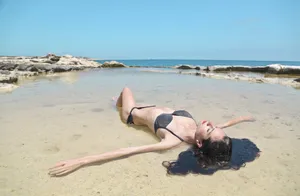 Happy model in bikini by the tropical beach