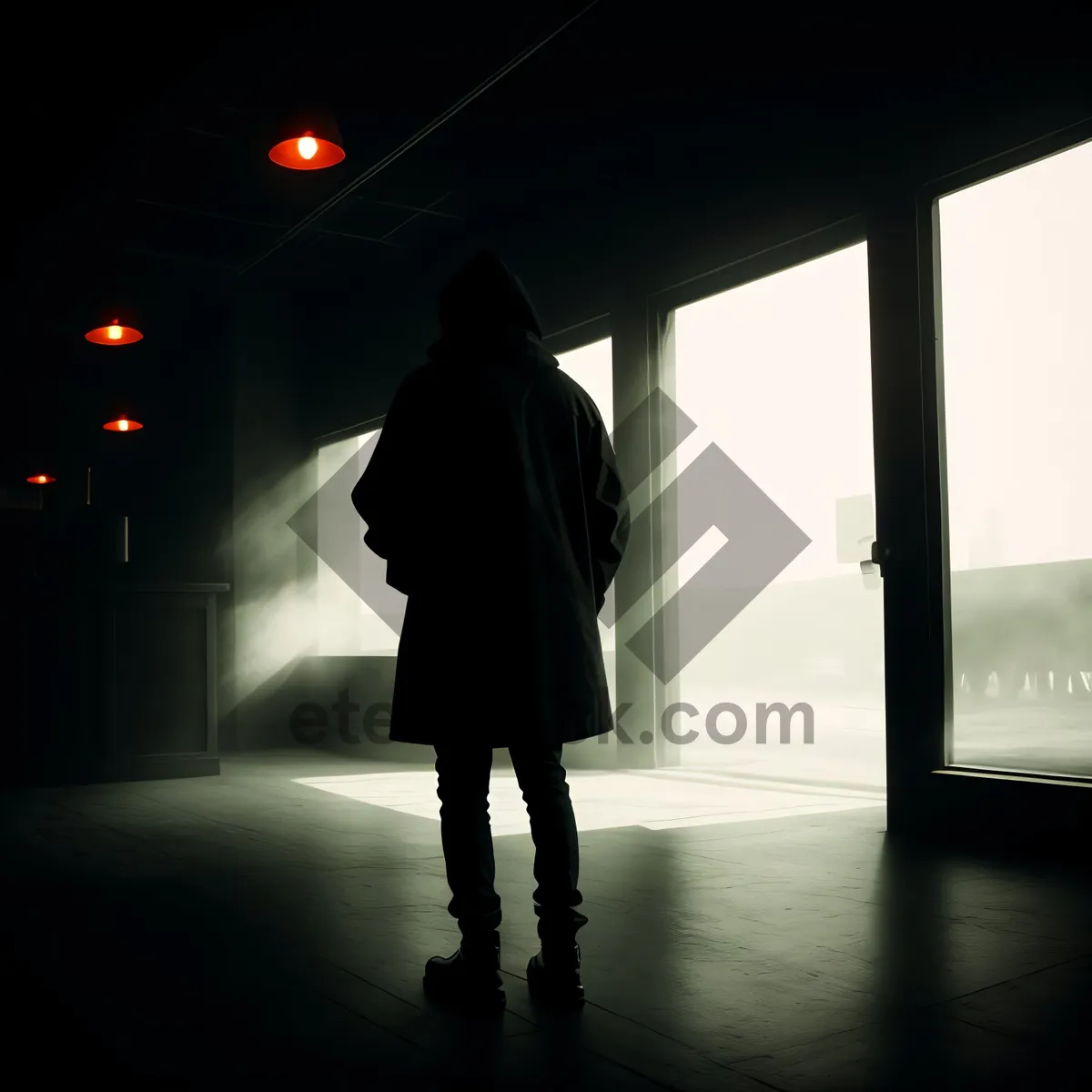 Picture of Urban Silhouette in Black Trench Coat Walking in Rainy City