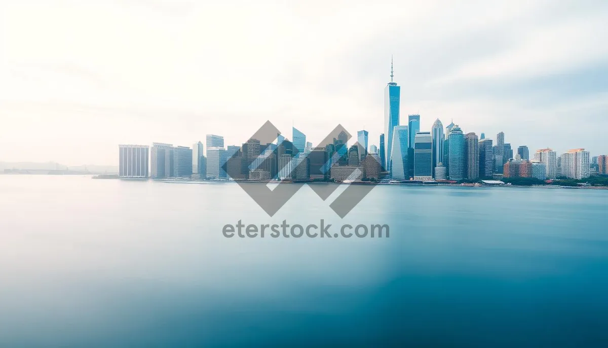 Picture of Modern skyscraper reflecting city skyline at dusk by river