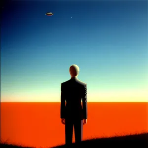 Silhouette of a Man with Briefcase at Sunset