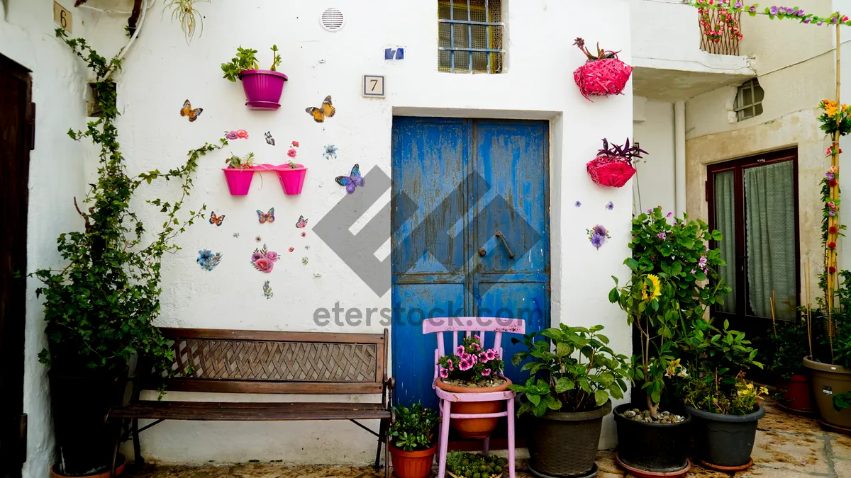 Picture of Residential container home with balcony and flower pot decoration.