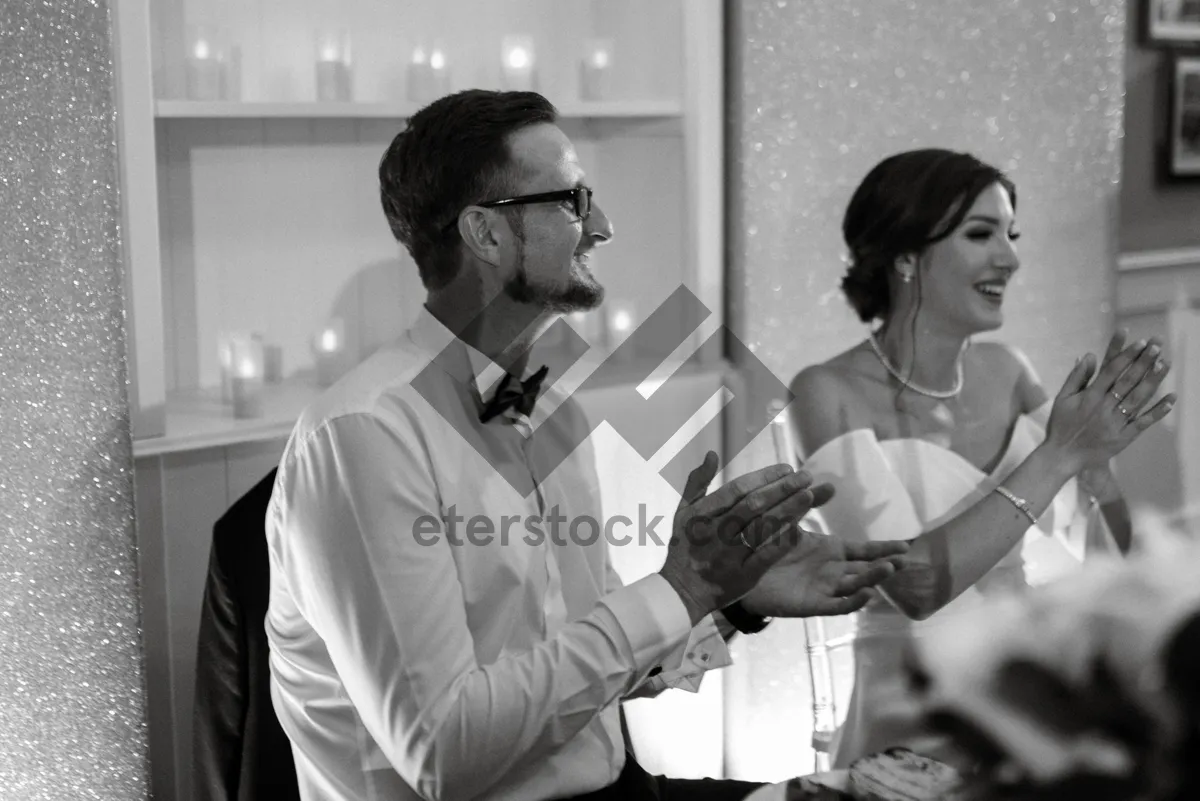 Picture of Happy male waiter sitting at hair salon.