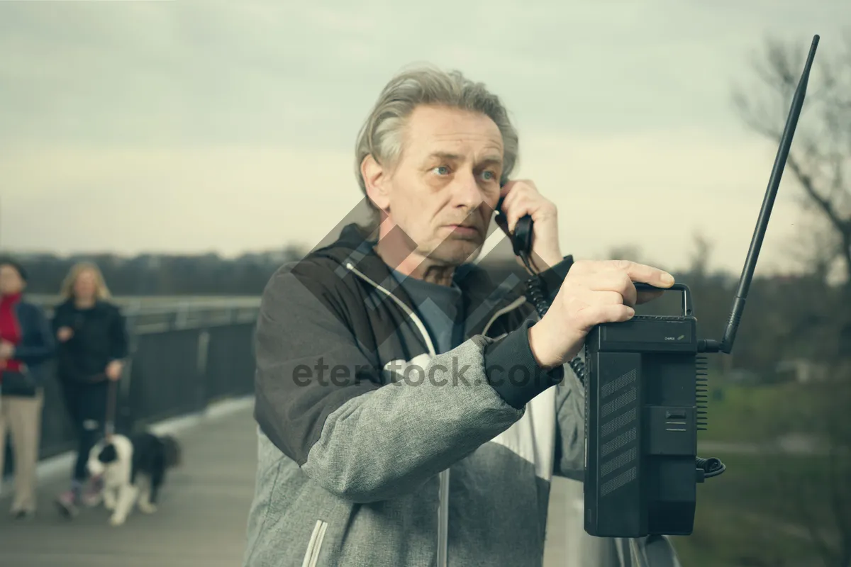 Picture of Professional businessman smiling with phone in hand.