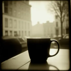 Hot morning coffee in a black mug.