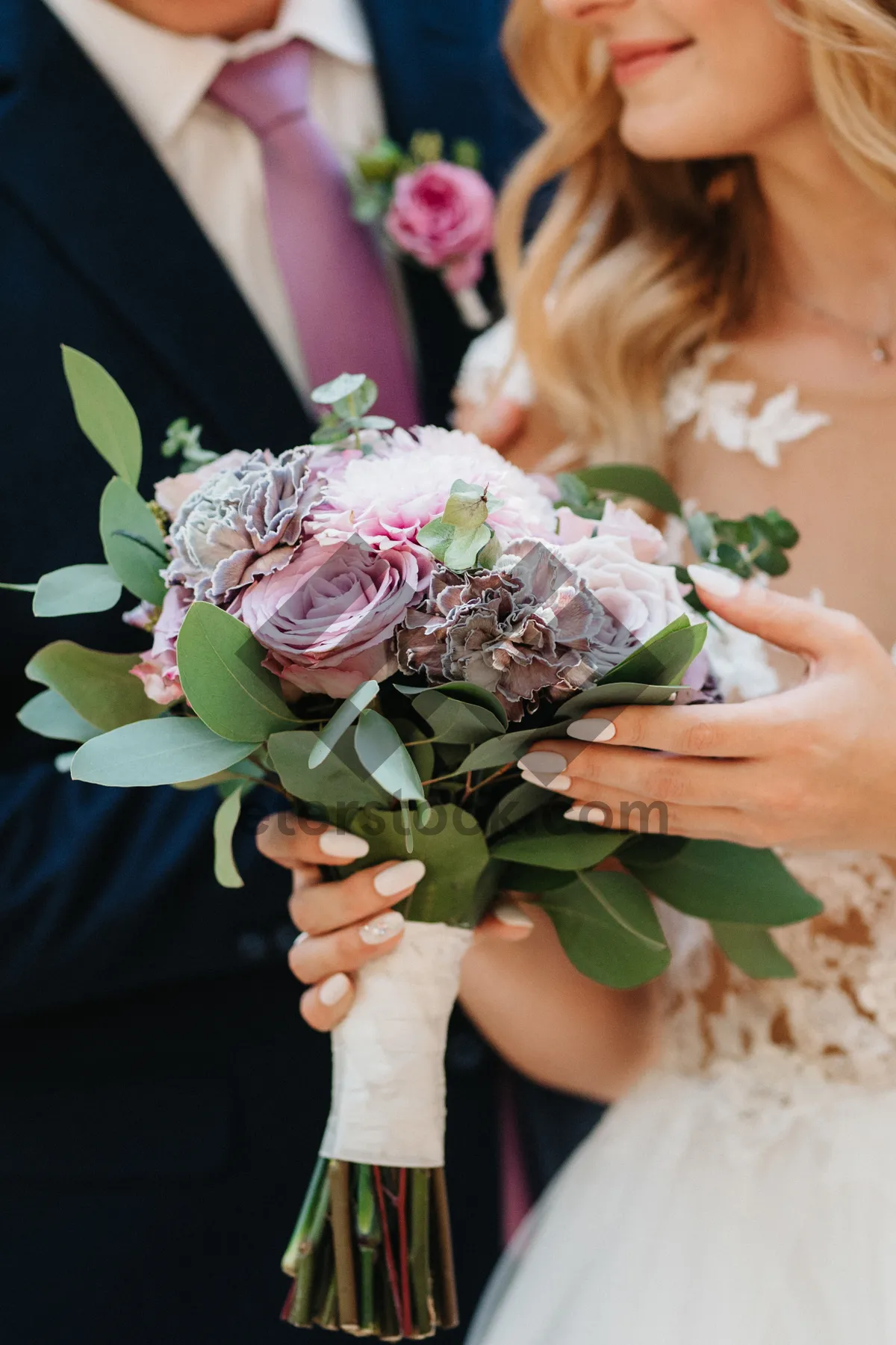 Picture of Happy wedding couple with rose bouquet in love.