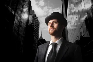Professional businessman in suit with tie standing confidently.