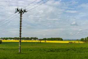 Yellow energy plant in rural landscape with clouds