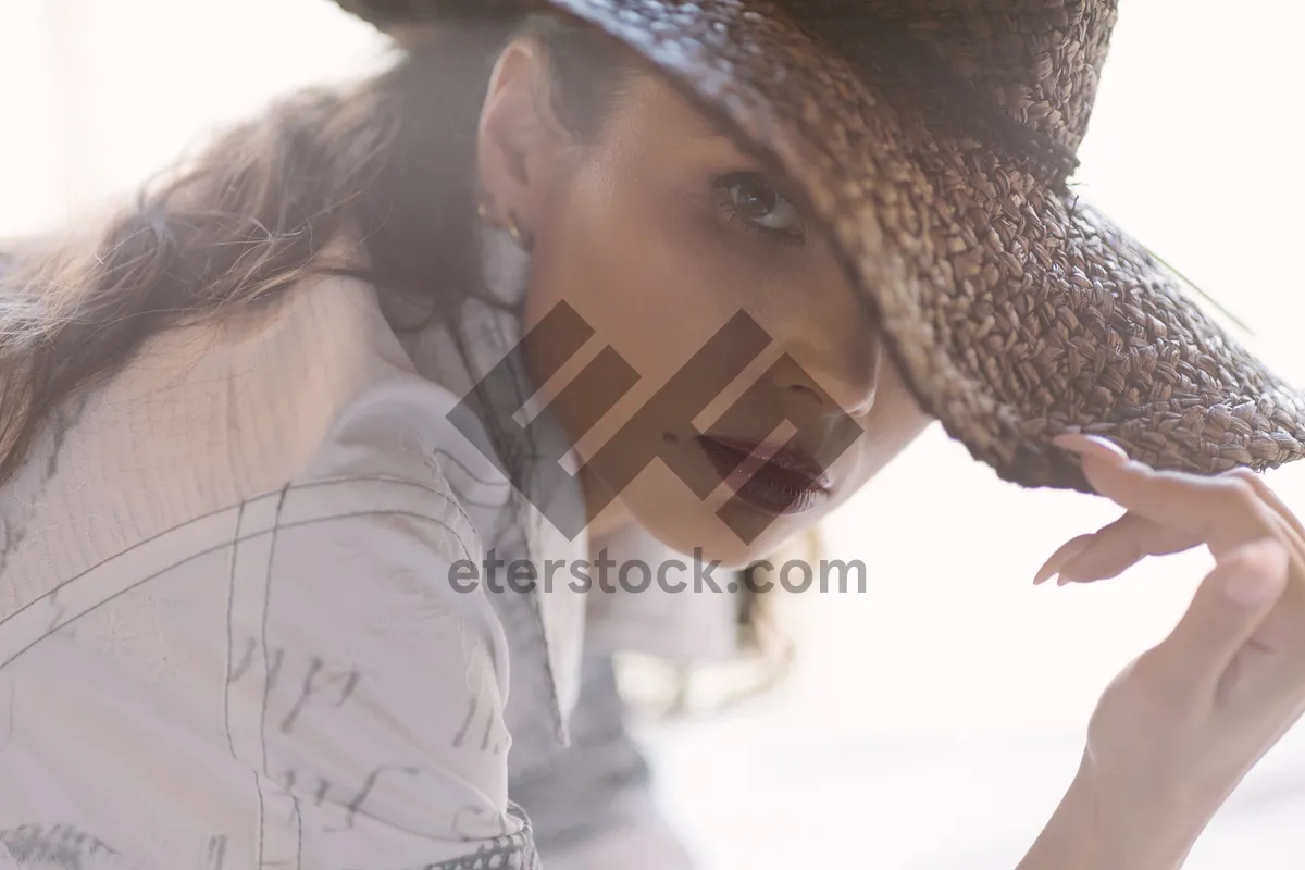 Picture of Attractive young woman in stylish cowboy hat smiling portrait.