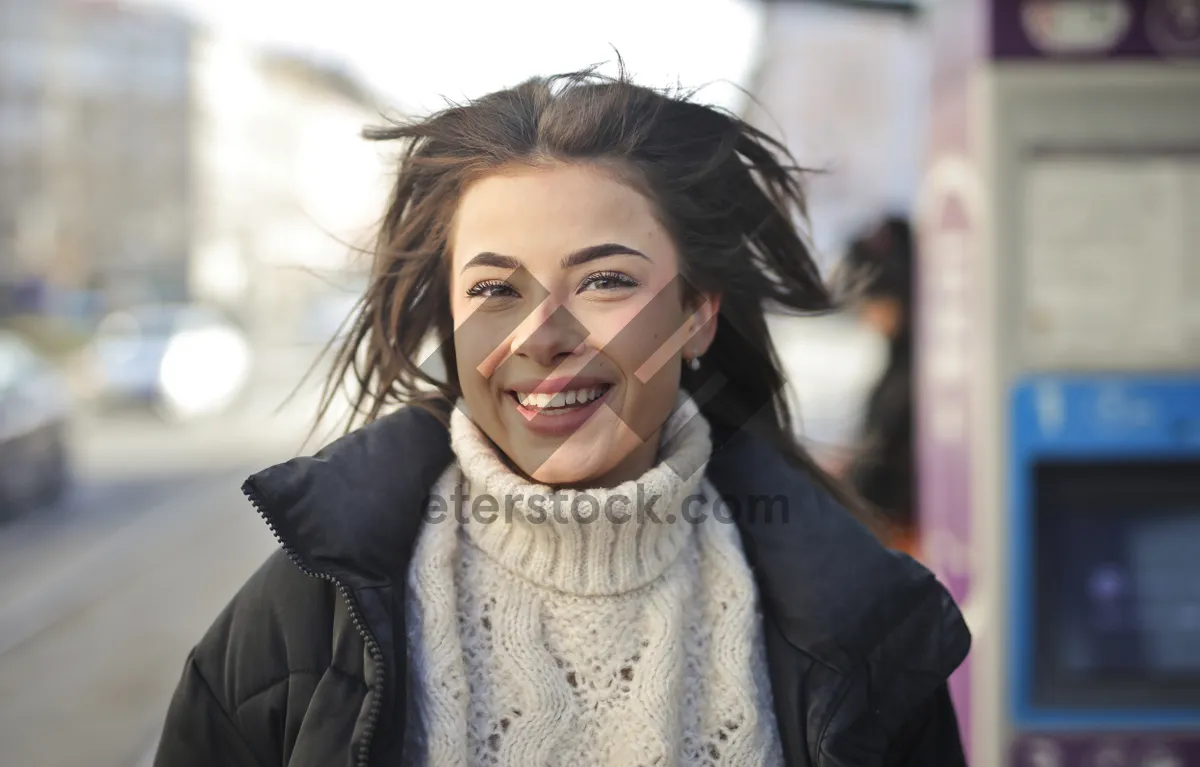 Picture of Smiling brunette lady wearing scarf with phone