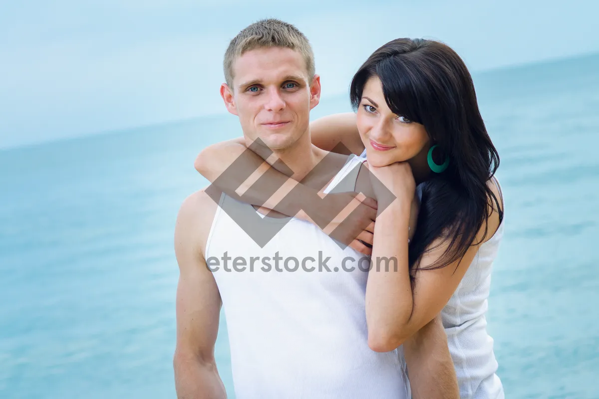 Picture of Attractive couple smiling on a beach vacation