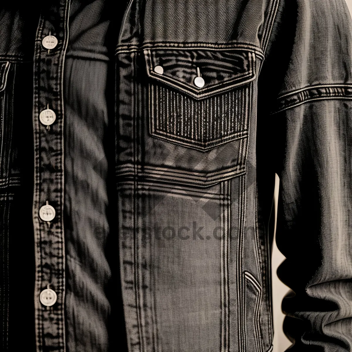 Picture of Jeans draped over architectural column, stylish garment.