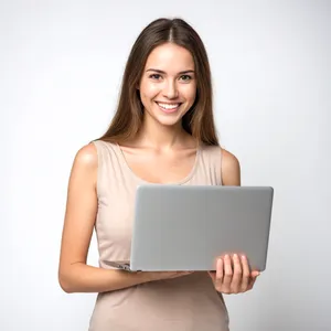 Happy brunette businesswoman working on laptop at home.