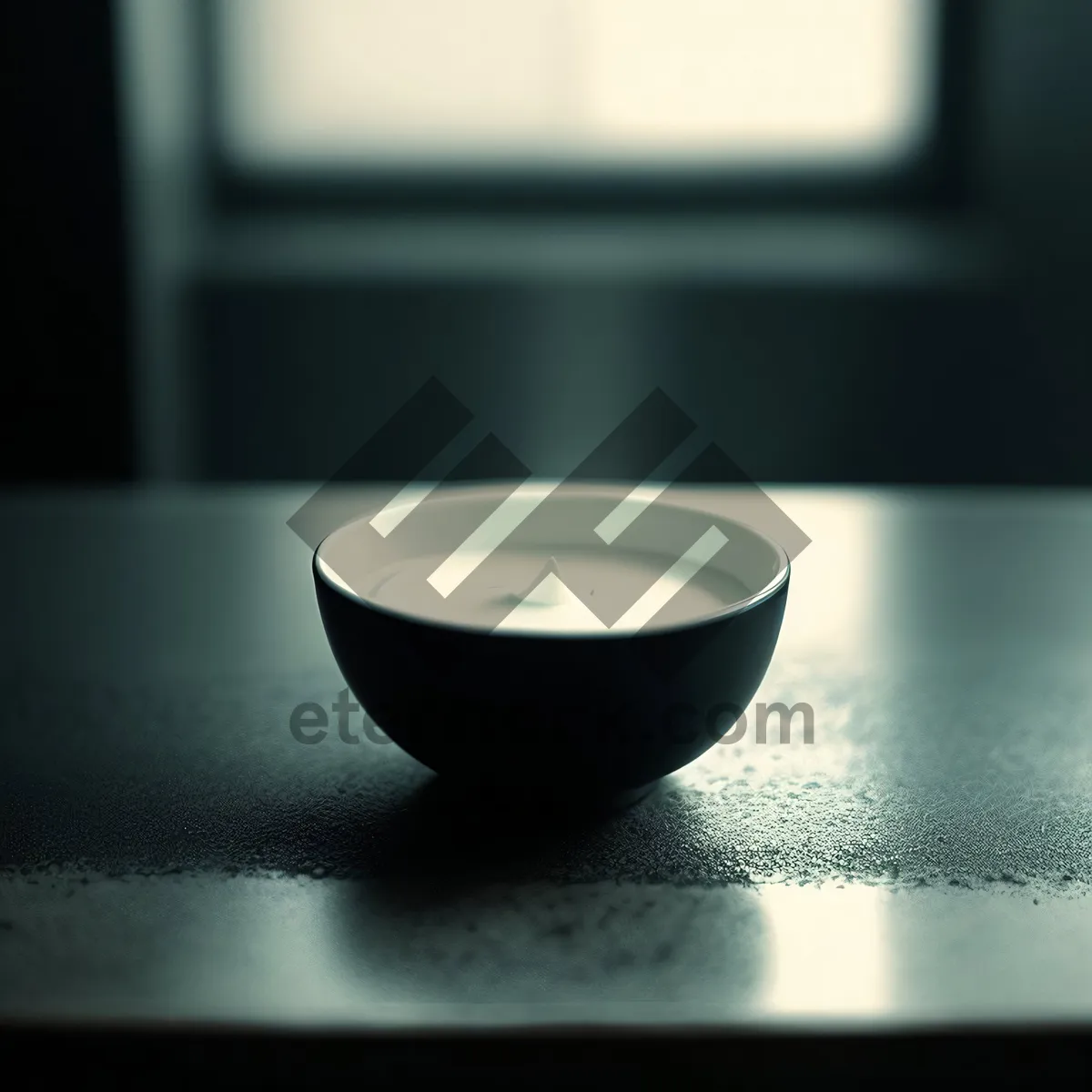 Picture of Hot Bowl of Soup with Black Spoon on Table