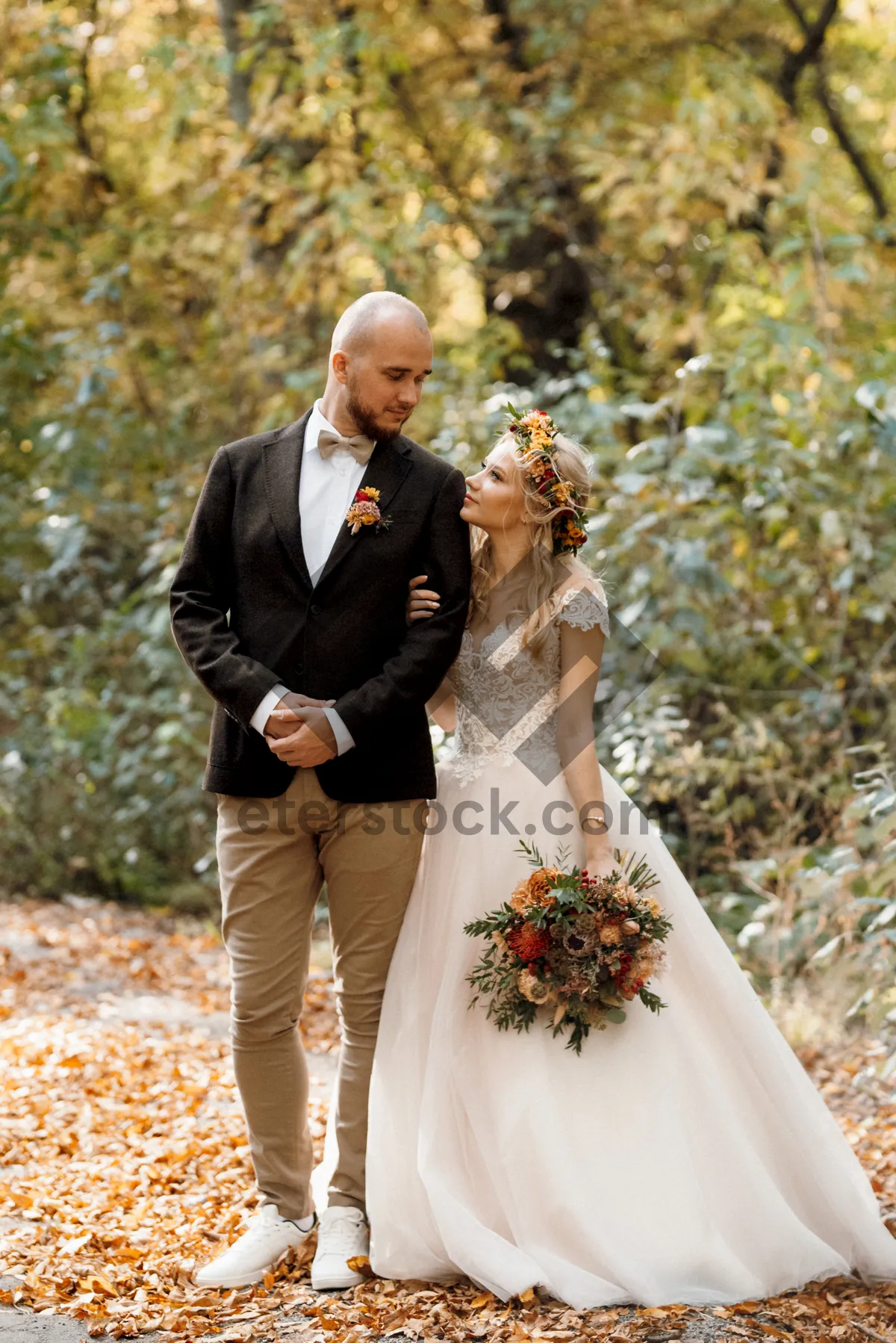 Picture of Happy couple in wedding attire smiling outdoors in love.