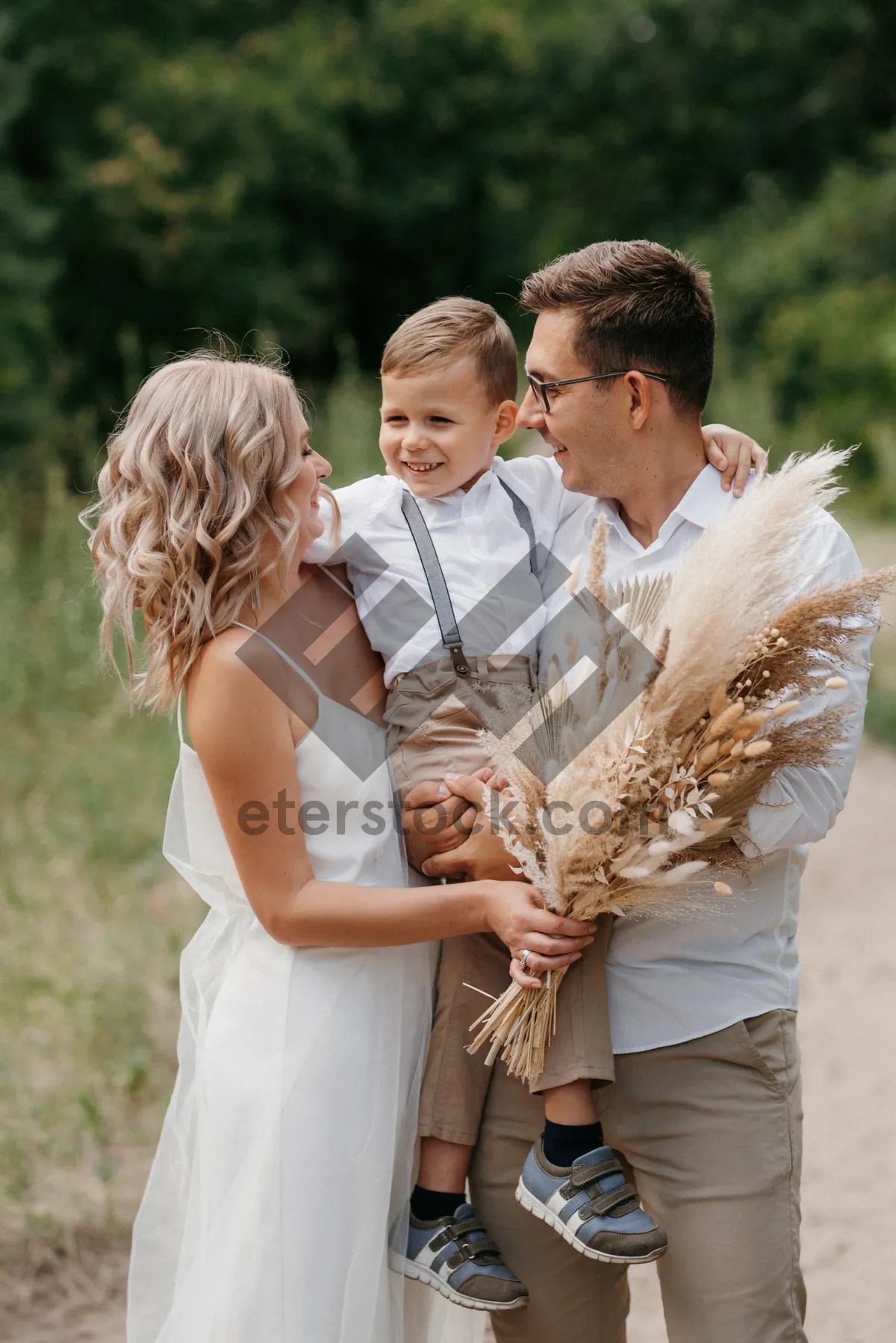 Picture of Happy couple wedding in summer park.