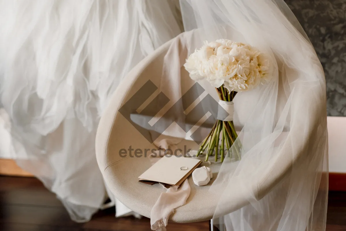 Picture of Wedding couple with rose bouquet at ceremony