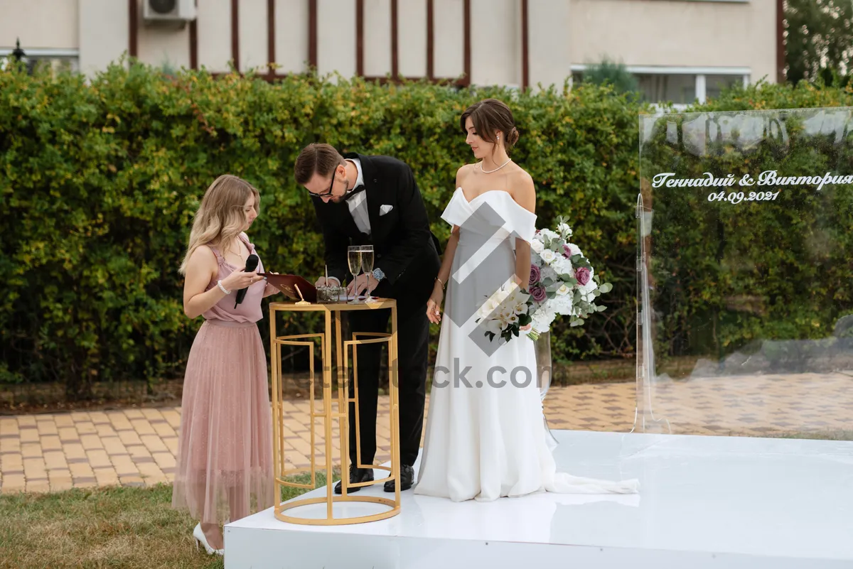 Picture of Happy couple celebrating their wedding day with flowers.