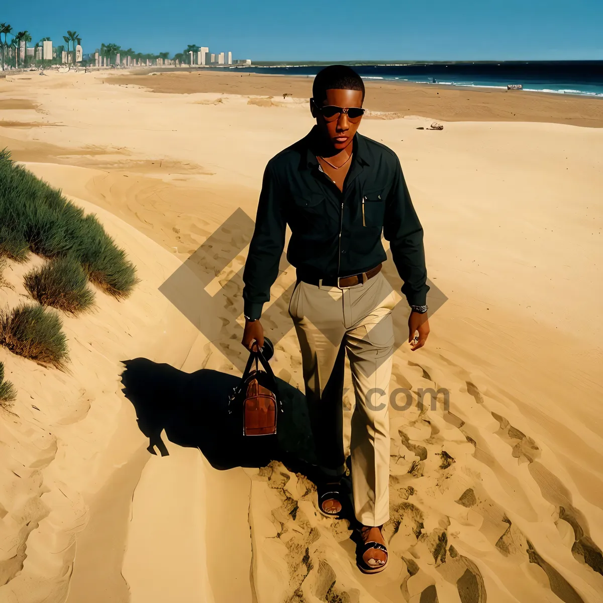 Picture of Man relaxing on sunny beach by the ocean