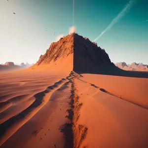 Sunset Over Desert Dunes: Majestic Sands and Mountain Peaks