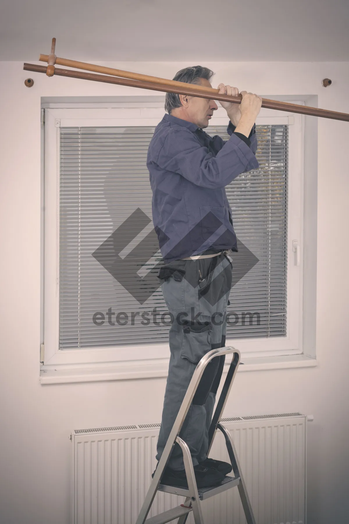 Picture of Man on unicycle cleaning device in street crowd.