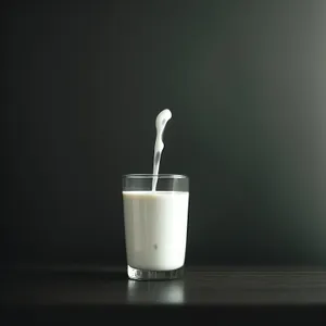 Hot morning coffee in a glass mug with spoon.