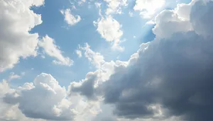 Clear blue sky with fluffy clouds on sunny day