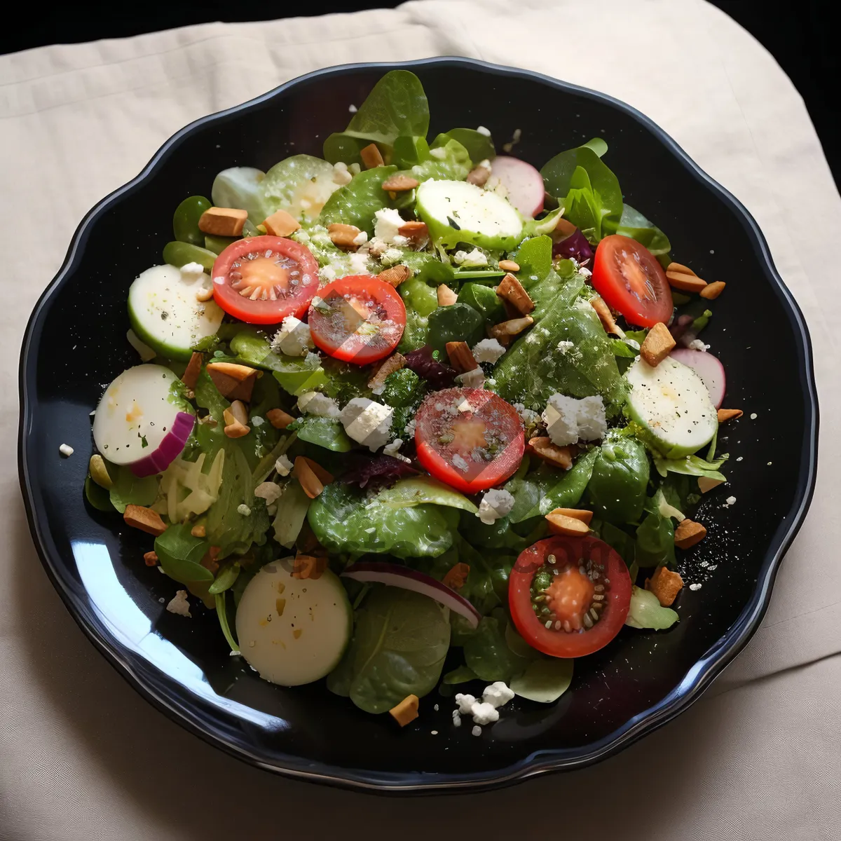 Picture of Grilled chicken salad with fresh vegetables and olives.