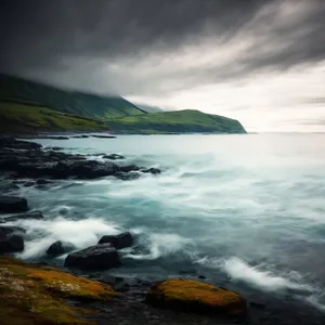 Serene Sunset Over Rocky Coastal Shoreline